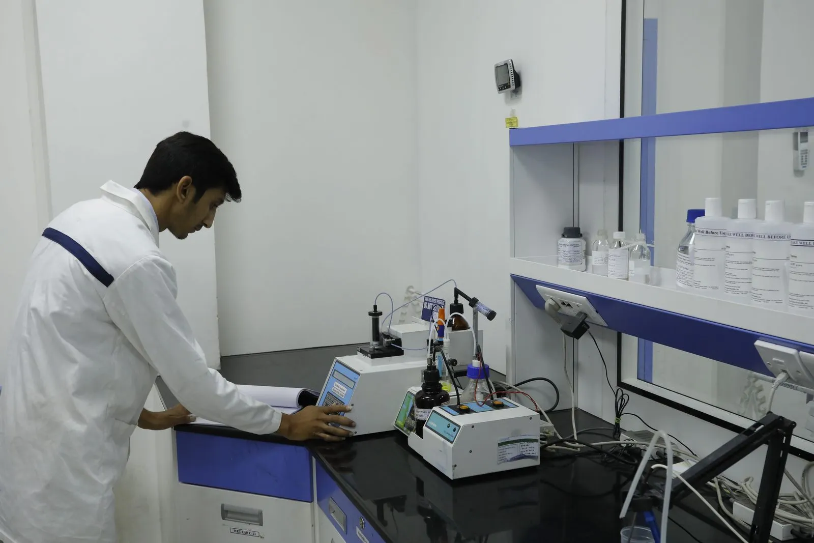 An Exemed employee working at a laboratory bench