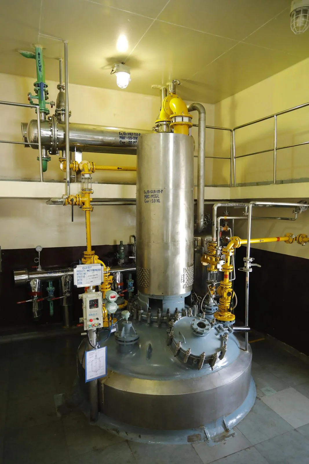 Pipework, valves and a vertical vessel in the Exemed plant